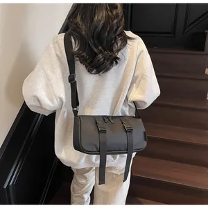 Rückansicht eines Models mit einer schwarzen Nylon-Zylindertasche mit Doppel-Schnallen