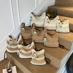 Large capacity woven shoulder bags in neutral tones with leather straps and cute charms