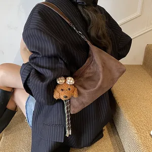Brown suede hobo shoulder bag with a cute puppy plush charm for casual office commuting