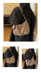 Detail view of khaki nylon crossbody bag featuring drawstring closure and small round pouch