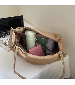 Interior view of khaki nylon tote bag showing large capacity for laptop and daily items
