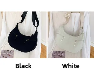 Detail view of nylon crescent bags in black and white with functional front zip pockets
