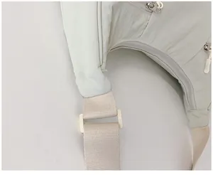 Close-up of light green nylon fabric texture and off-white woven shoulder strap detail