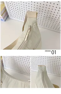Detail view of smooth zipper closure and textured nylon fabric on light green crescent bag