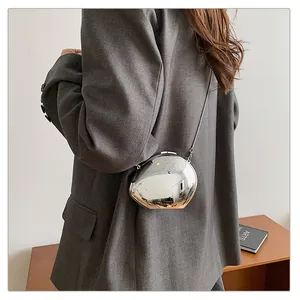 Chic silver mirror pebble-shaped metal clutch bag with a sleek chain shoulder strap