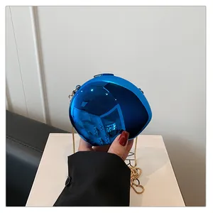 Detail shot of the spherical blue mirror evening bag with gold chain and metal clasp