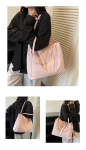 Detail view of pink fabric tote bag showing large capacity and soft texture in daily use