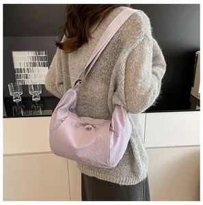 Detail of lavender nylon tote bag featuring drawstring texture and wide shoulder strap