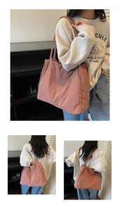 Detailed side view of a large dusty pink casual tote bag made of soft lightweight nylon