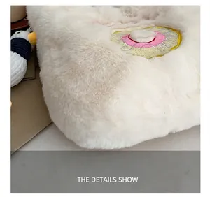 Detail of soft white faux fur tote bag with colorful donut embroidery and fine stitching