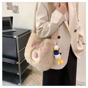 Detail of plush tote bag with Sweet embroidery and cute duck charm in lifestyle setting