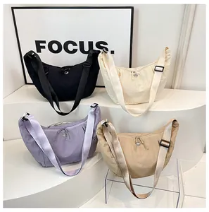 Detailed display of crescent nylon crossbody bags in four colors with wrinkled texture