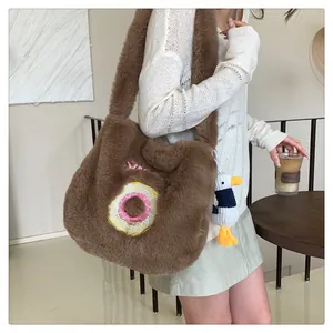 Detail of brown faux fur tote bag with donut embroidery and cute plush duck charm