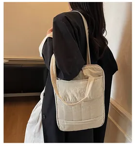 Minimalist beige quilted shoulder bag shown on model for daily commuting style