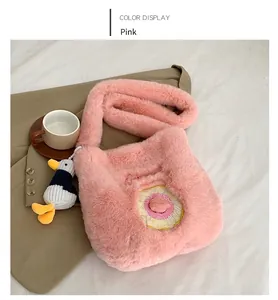 Detail of pink faux fur crossbody bag featuring sweet donut embroidery and duck charm