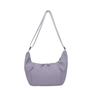 Minimalist lavender crescent crossbody bag with pleated nylon fabric and adjustable strap