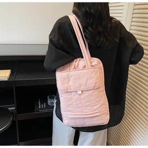 Detailed back view of pink quilted laptop bag with spacious front pocket for commuting