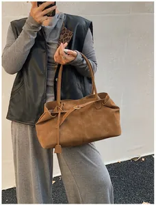 Detail of vintage brown wax leather tote with textured finish and long shoulder straps