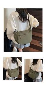 Detail view of olive green crescent crossbody bag with adjustable wide shoulder strap