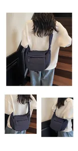 Detail of navy blue nylon crossbody bag featuring large capacity and wide shoulder strap