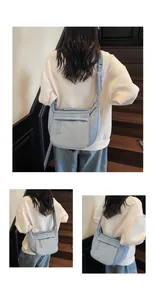 Detail of light blue quilted nylon crossbody bag with adjustable wide strap and front zipper