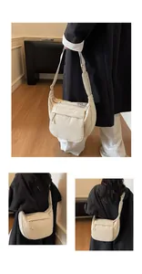 Detail view showing the layered nylon structure and adjustable wide strap of the cream bag