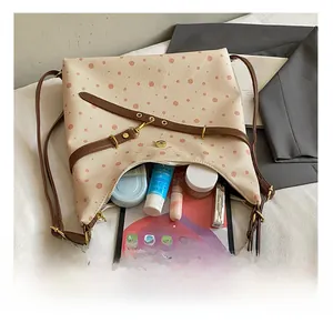 Detail view of large capacity polka dot tote bag showing space for tablet and makeup