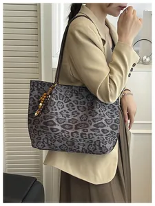 Leopard print tote bag with wooden bead pendant detail on shoulder strap for women