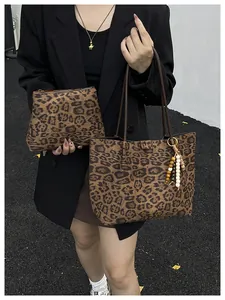 Detail of leopard print tote bag set featuring plush fabric and stylish wooden bead charm