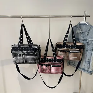 Punk style large crossbody bags with houndstooth patterns and metal eyelet details