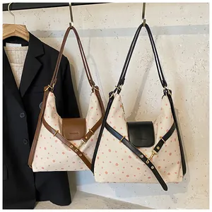 Detailed comparison of pink polka dot canvas hobo bags with black and brown leather trims