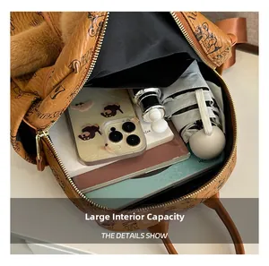 Top view of the spacious black fabric interior of this brown leather backpack