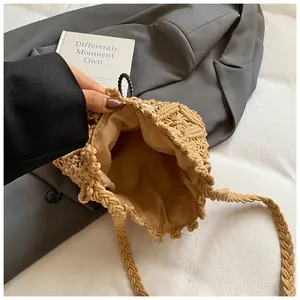 Macro shot of khaki woven bucket bag with thick rope texture and soft fabric lining
