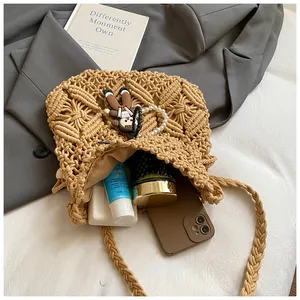 Interior view showing the capacity of a woven bucket bag with phone and cosmetics