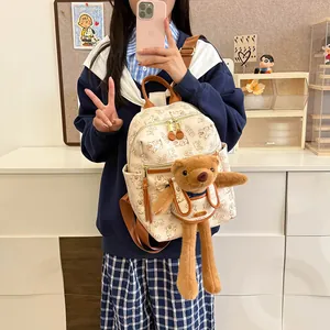 Fashionable cream backpack with cartoon bear prints and cute 3D plush doll accessory
