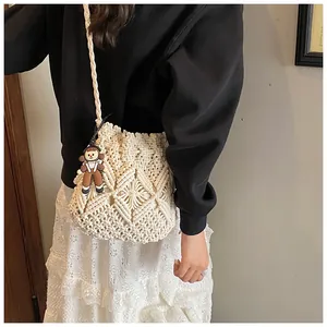 Macro shot of ivory hand-woven crochet bag with intricate geometric diamond textures