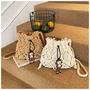 Detail of hand-woven bucket bags with geometric patterns and cartoon charms on stairs