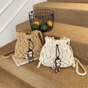 Handwoven bohemian straw bucket bags in brown and white with decorative cute charms