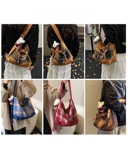 Detail showing vintage plaid canvas tote bag with drawstring closure and cute lamb charm