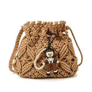 Handwoven bucket bag with diamond texture and cute girl pendant on white background