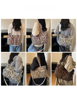 Detail of leopard print tote bag with double front zip pockets and wide shoulder straps