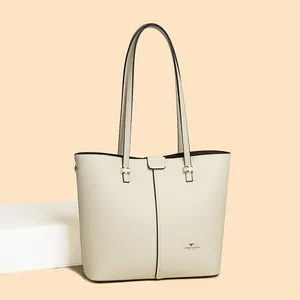 Detail of lychee textured faux leather tote with golden hardware and kangaroo logo