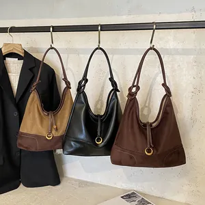Three vintage faux suede and leather hobo tote bags with ring and knot strap details