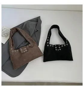 Detail of rivet trim and matte suede texture on chic brown and black hobo bags