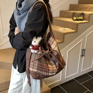 Vintage brown plaid tote bag with suede拼接, drawstring bow and plush bear pendant detail