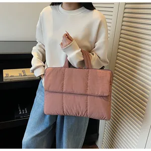Detailed side view of lotus pink quilted tote bag showing square stitching and front pocket
