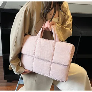 Close-up of pink quilted puffer tote bag with satin finish and double top handles