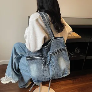 Washed blue denim tote bag for women with double zippers and retro casual shoulder style