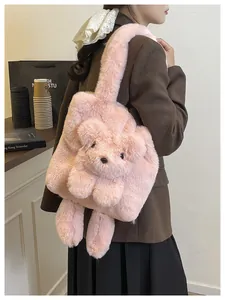 Detail view of pink plush teddy bear shoulder bag on a model for autumn style