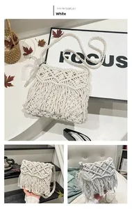 Detail of bohemian woven cotton crossbody bag with geometric patterns and fringe